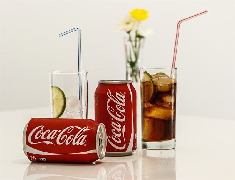 #2 COCA-COLA: American pharmacist John Pemberton invented this beverage based on cola nut and coca plant as a cure for morphine addiction History Story: #2 COCA-COLA: American pharmacist John Pemberton invented this beverage based on cola nut and coca plant as a cure for morphine addiction