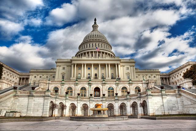 What figure crowns the dome of the US Capitol in Washington DC?
