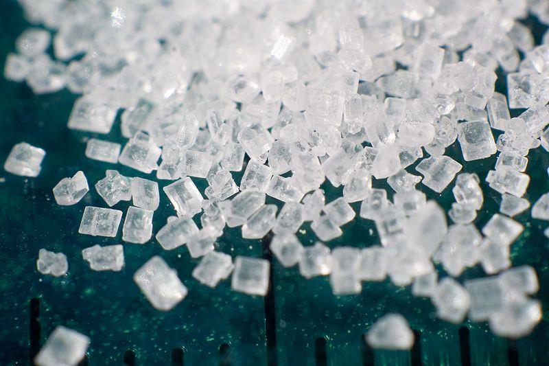 Approximately how much refined sugar does the average American consume per year?