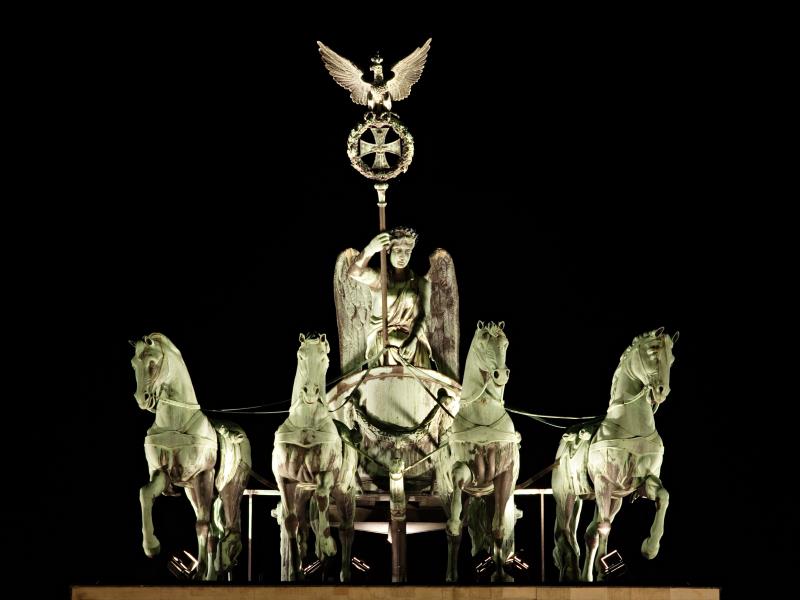Where is one standing if he or she is standing before the Brandenburg Gate?