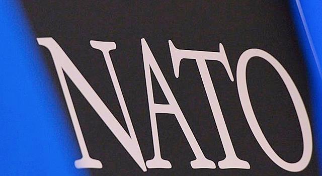 What symbolic emblem is found on NATO's flag? What symbolic emblem is found on NATO's flag?