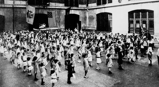 Why are the children in the photograph saluting the US Flag in that manner? Why are the children in the photograph saluting the US Flag in that manner?