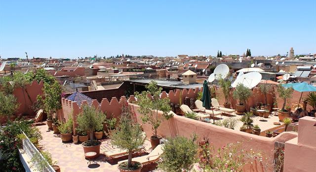 Which Moroccan city is known as the "red city" for its rose colored clay buildings?