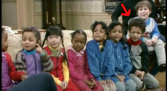 Who is this famous person when younger (seated on far right on sofa)?